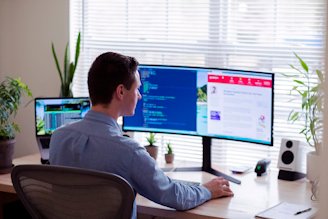 Man at a computer showing example website